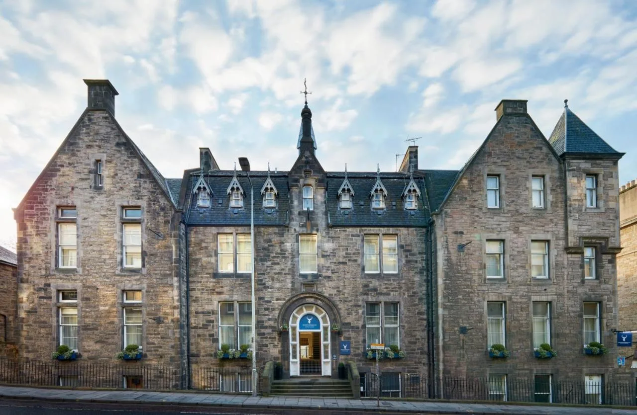 an old brick building with a cross on top at Leonardo Edinburgh City in Edinburgh