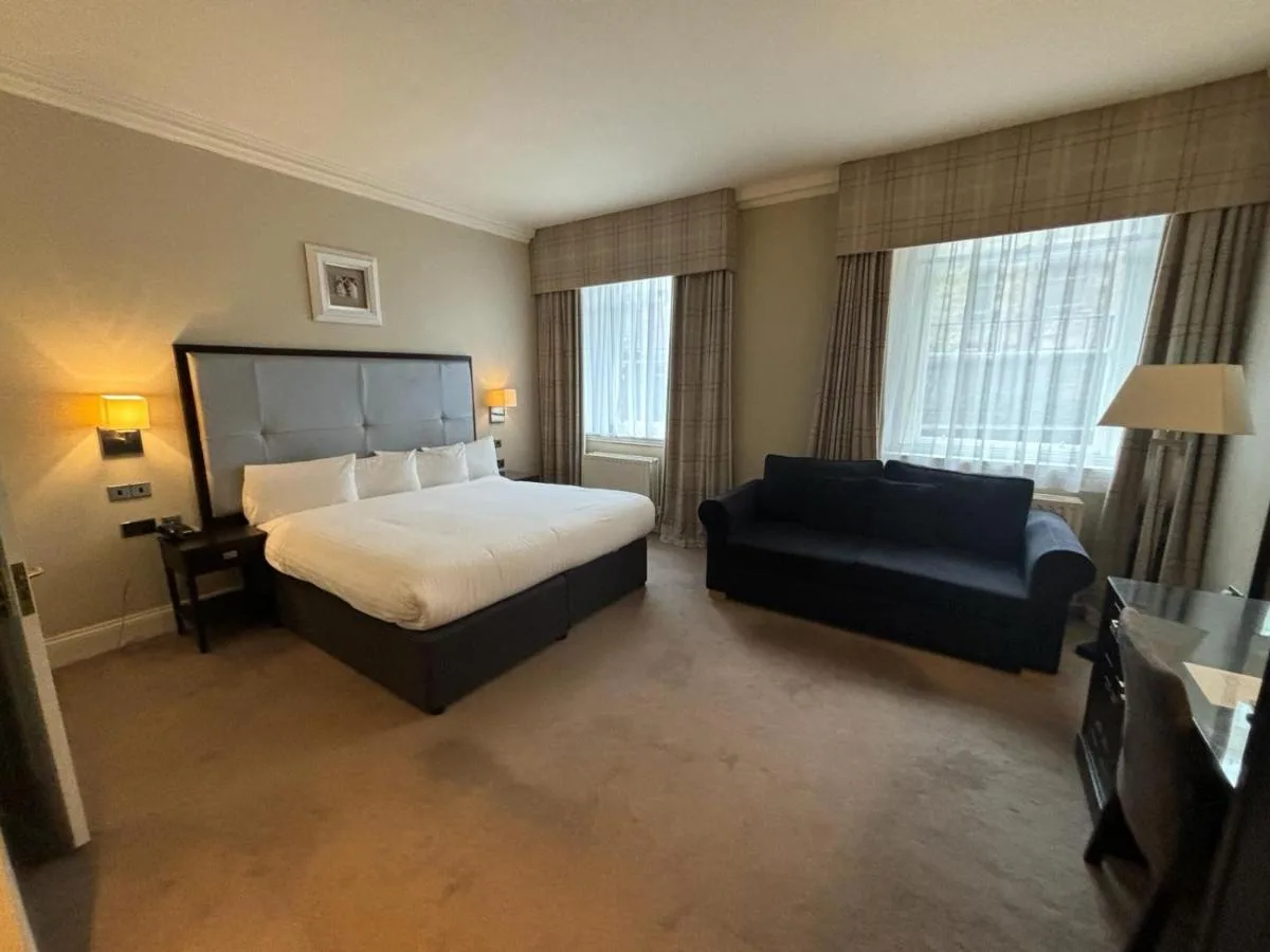 a hotel room with a bed and a couch at Leonardo Edinburgh City in Edinburgh
